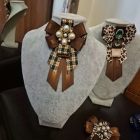 Green and brown bow brooch