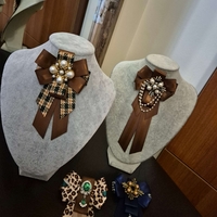 Green and brown bow brooch