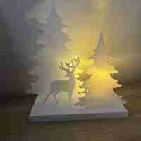 Светещ декор с елен в гора