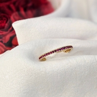 Златен пръстен с циркони цвят малина , тип халка