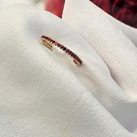 Златен пръстен с циркони цвят малина , тип халка