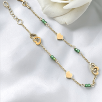 Златна гривна със сърчица и зелени цирконий