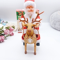 Decoratiune Mos Craciun, Flippy, Animat, care Canta si Danseaza, cu Saculet, pe Ren, Imbracat Festiv, 28x21x10 cm, Rosu