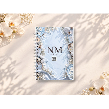 Корица на NMhandmade седмична таблица за SPA и масажи, колекция LUMINOUS 2027, със спирално подвързване, представена върху светъл фон с декоративни цветя.
