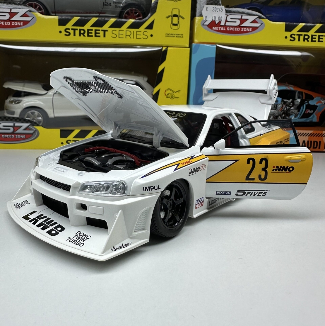 Метална кола с отварящи се врати, светлини и звуци  Nissan Skyline GT-R R34 1:24