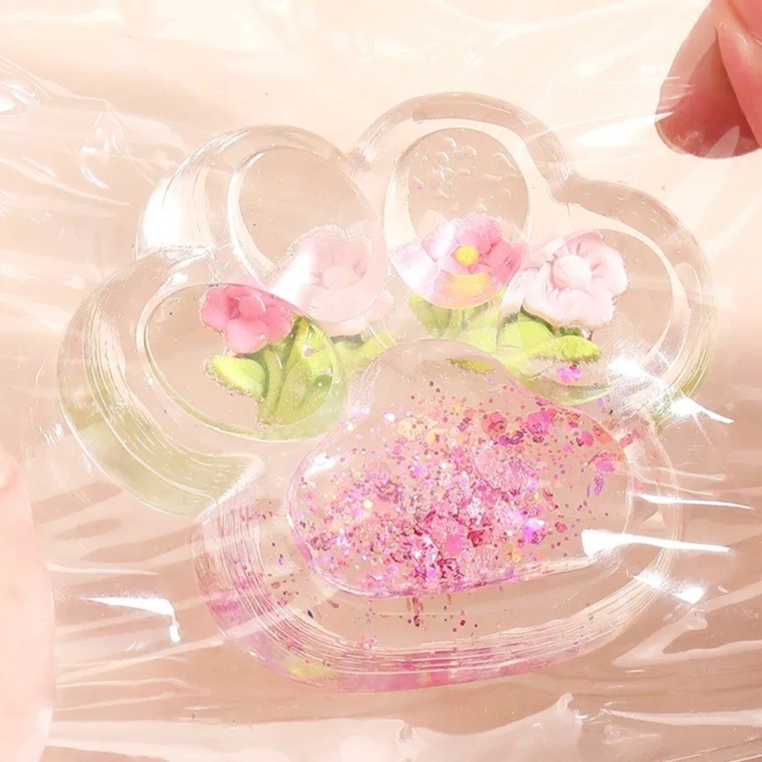 Jucarie Antistres Squishy, Flippy, Labuta de Pisica Pufoasa, cu Revenire Lenta, 7 x 6.5 cm, Model Flori 1, Transparent
