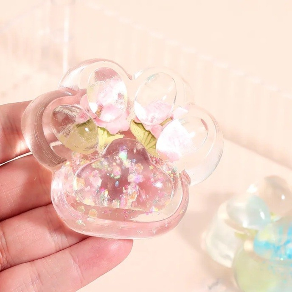 Jucarie Antistres Squishy, Flippy, Labuta de Pisica Pufoasa, cu Revenire Lenta, 7 x 6.5 cm, Model Flori 1, Transparent