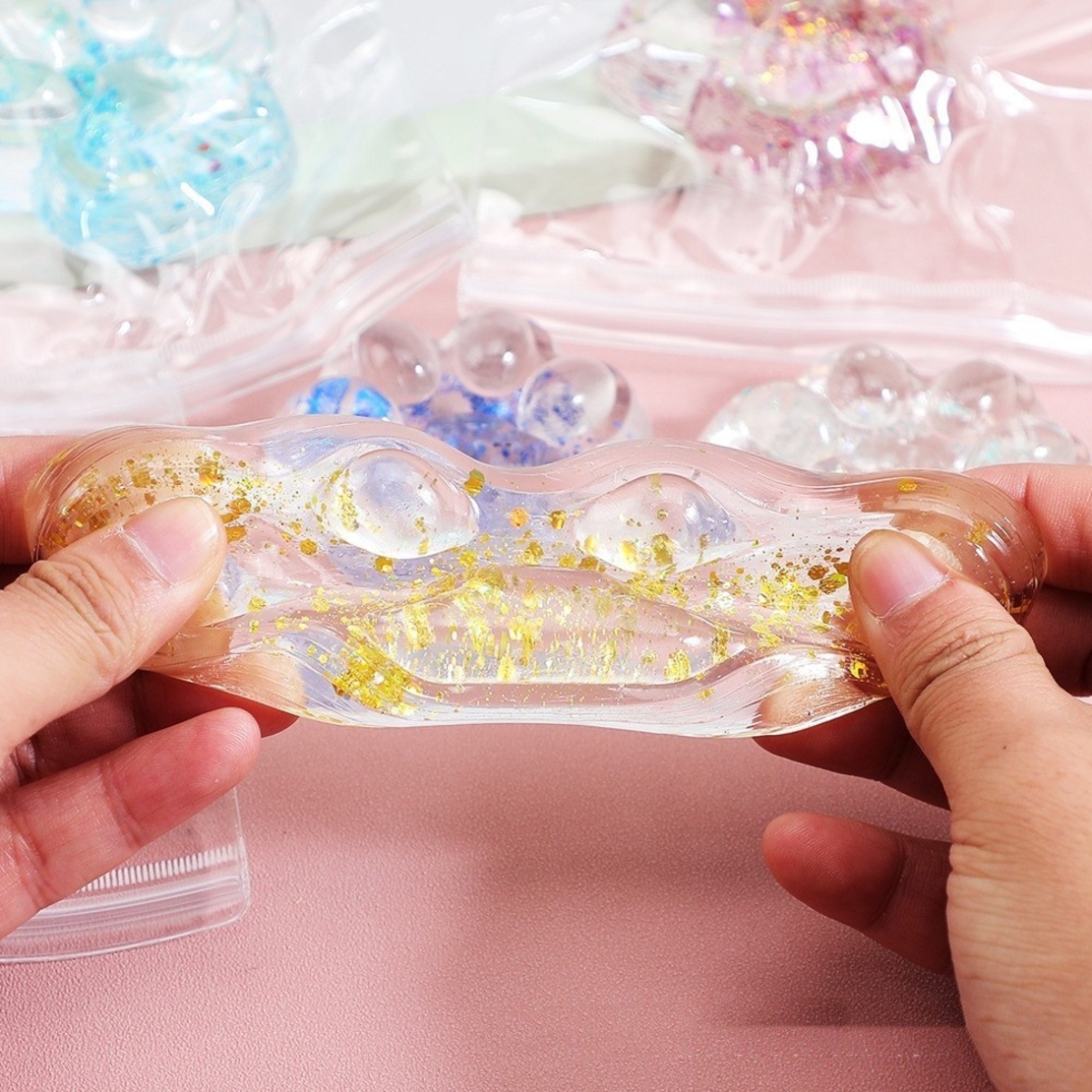 Jucarie Antistres Squishy, Flippy, cu Revenire Lenta, Squeeze Pinch Family, Model Cat Paw, 6.5 x 7 cm, din Tpr, 4-6 Ani, Model 4 Sclipici, Transparent