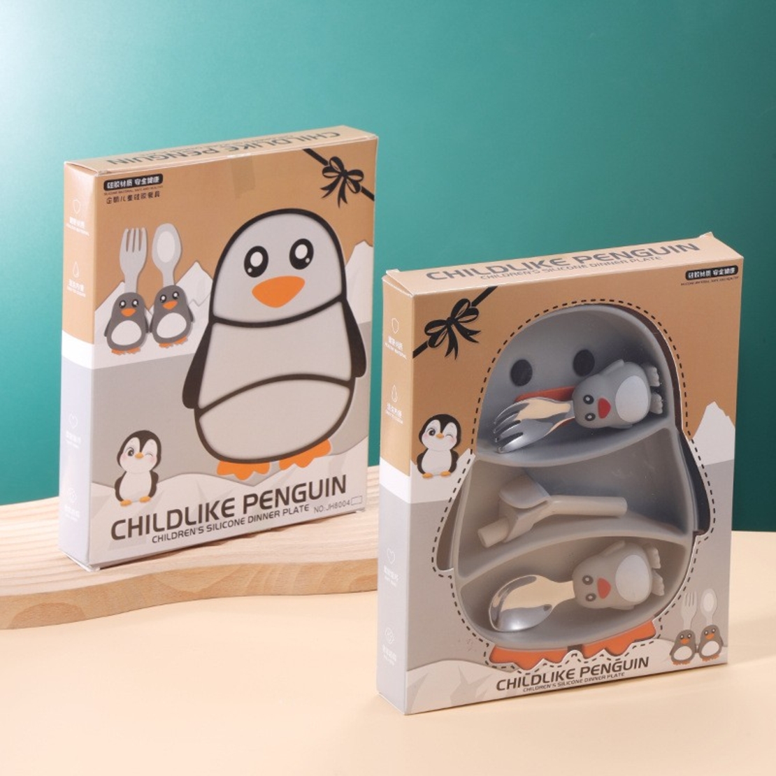 Set diversificare bebelusi Flippy, din silicon, 23.5 x 12.5 cm, 1 farfurie compartimentata in forma de pinguin, lingurita si furculita, pai, perie pai, fara alergeni, ventuza fixare, forma creativa, gri